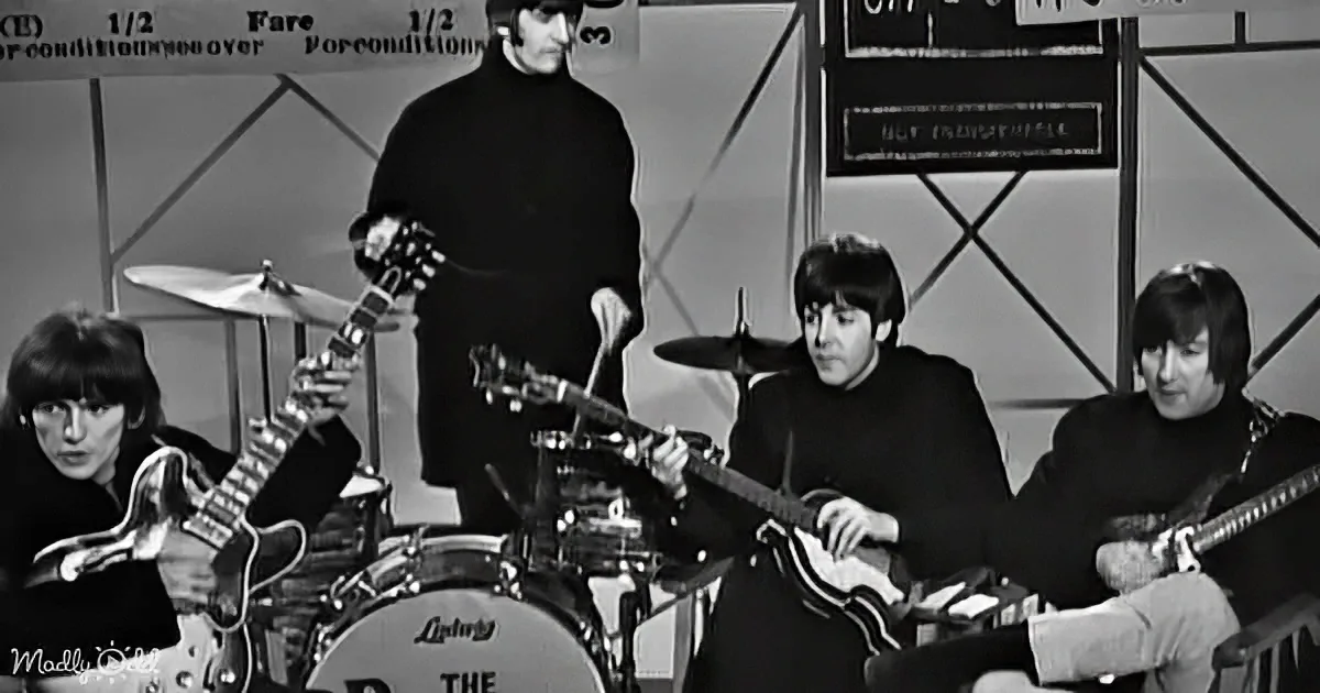 The Beatles perform live, with John Lennon on lead guitar, Paul McCartney on bass, Ringo Starr on drums, and George...