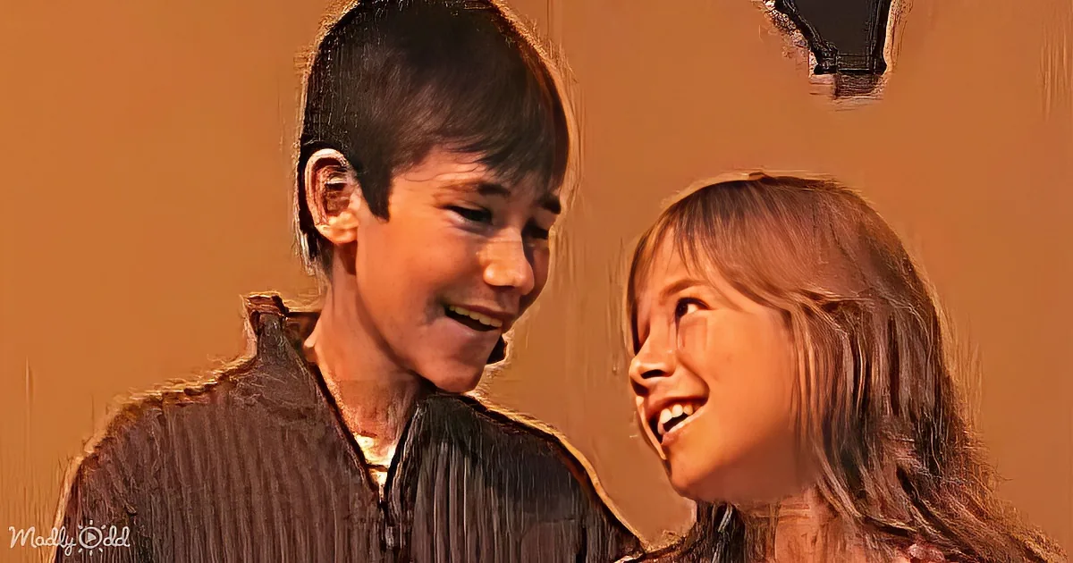 A boy and girl share a warm, joyful moment, both smiling and looking at each other.