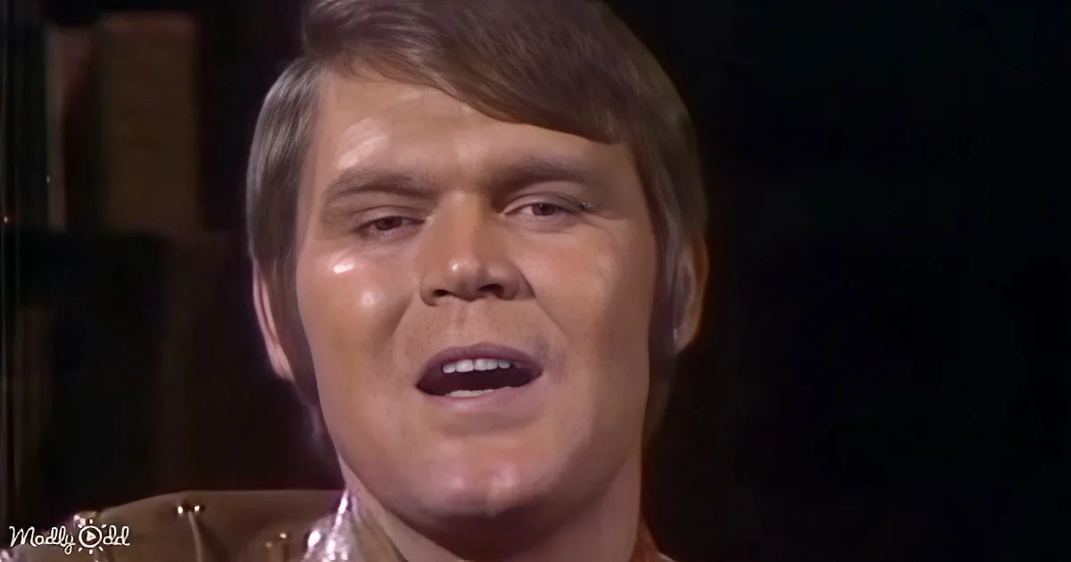 A person with short brown hair and a brown leather jacket is shown in a close-up shot.