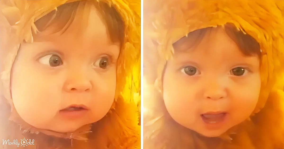 A child with dark hair and a yellowish tint, looking surprised or curious.