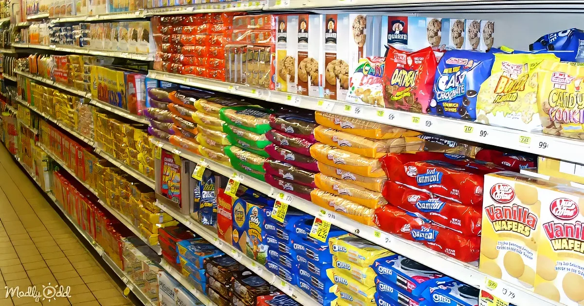 A grocery store aisle displays a variety of cookies and snacks, including Oreo, Quaker, and Nabisco products.