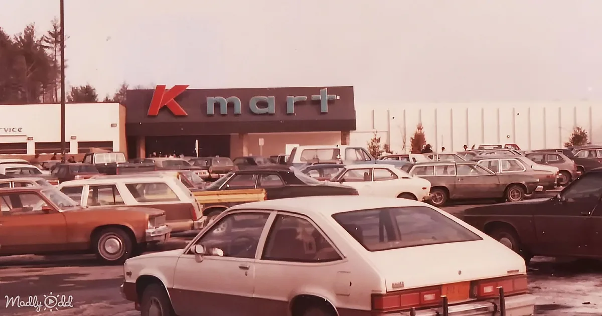 A Kmart store with a large parking lot filled with vintage cars.