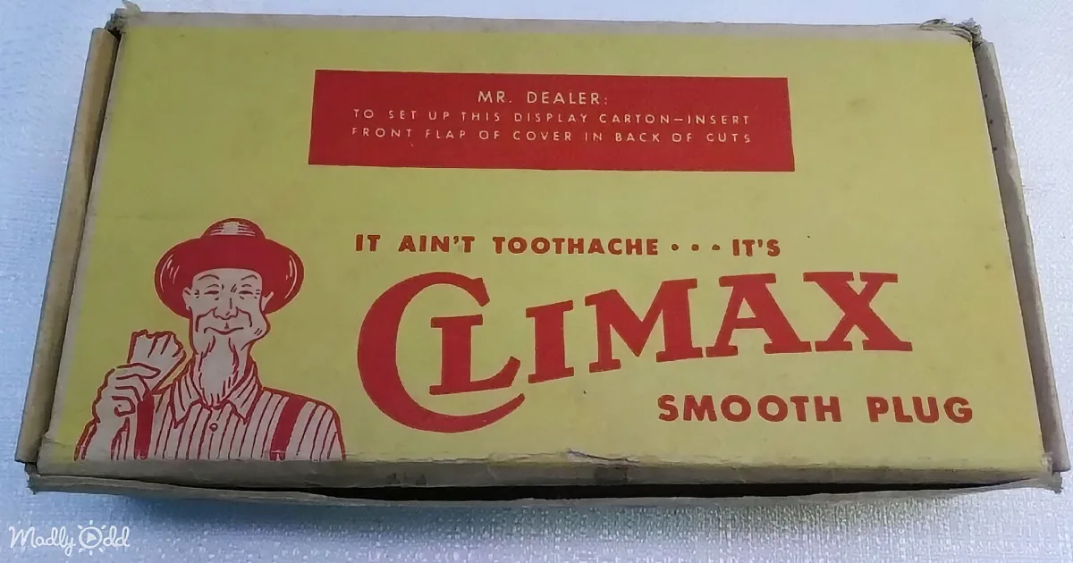 A vintage Climax Smooth Plug tobacco box with a cartoon farmer and instructions for dealers.