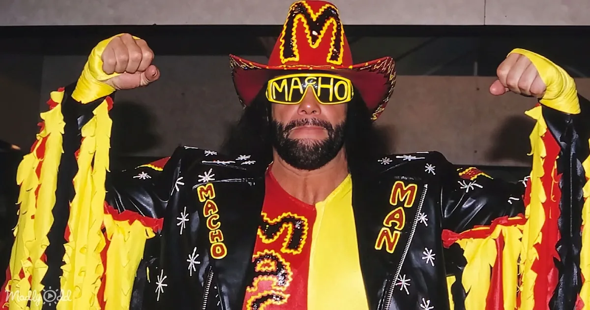 A wrestler in a vibrant yellow and red outfit, with "MACHO MAN" written on his jacket and hat, flexes his muscles.
