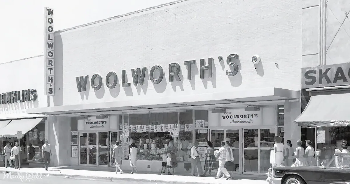 Woolworth's store facade with people walking, vintage signage, and cars parked in front.