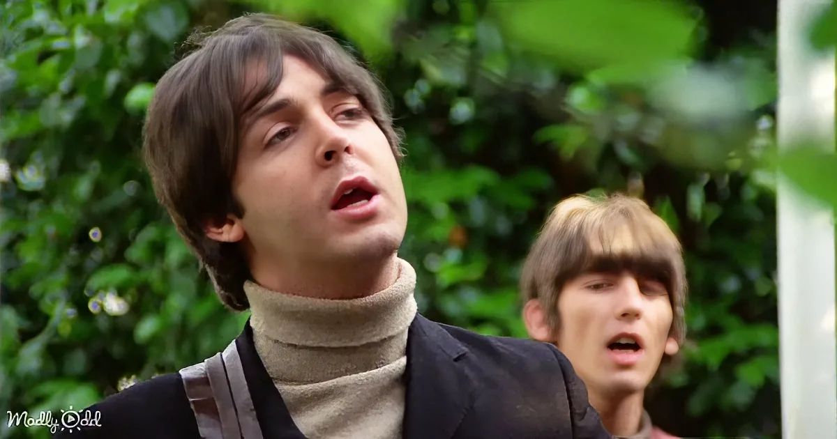 A man in a turtleneck and blazer looks upward, another man in the background appears surprised.
