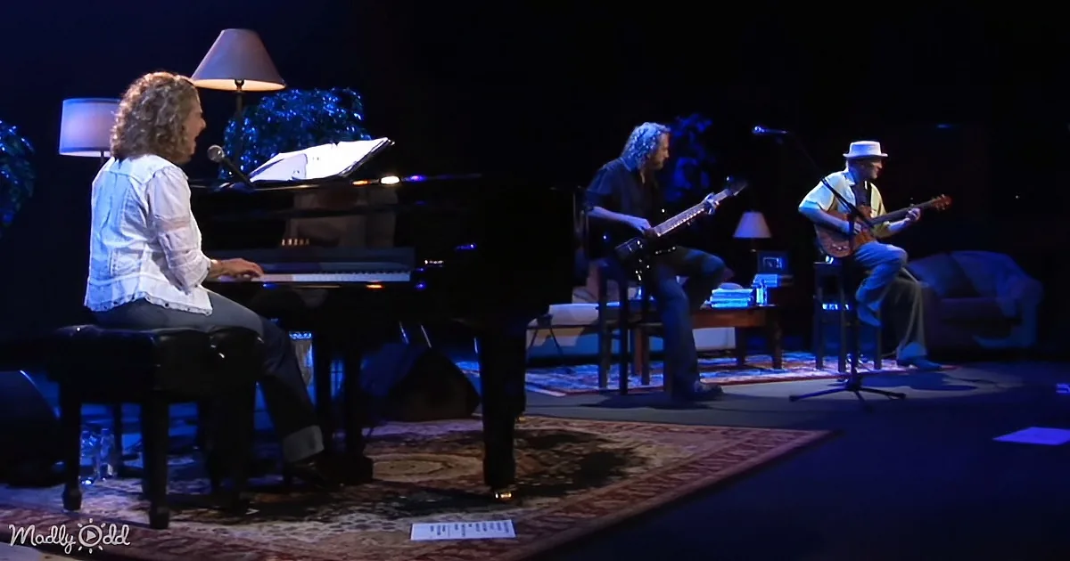 A woman plays piano as two musicians, one on guitar and the other on banjo, accompany her on stage.