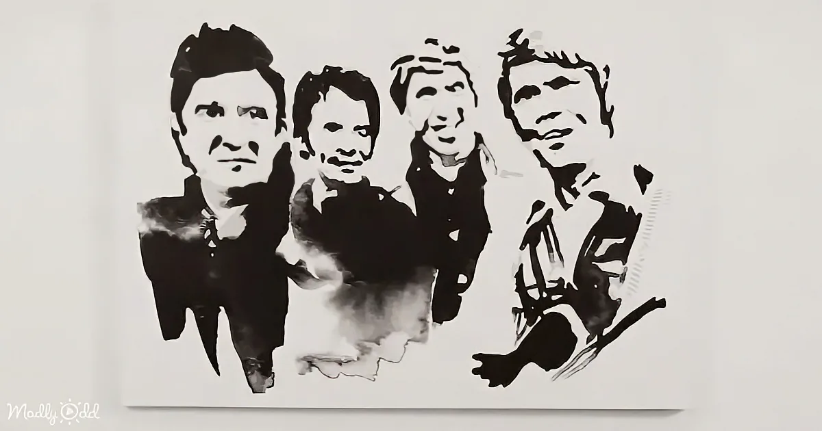 A black and white stencil art of four men in suits, one holding a cigarette.