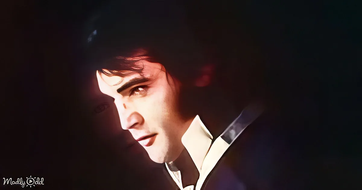 A man in a suit with a white shirt and tie, looking to the side, with a dark background and a light source highlighting...