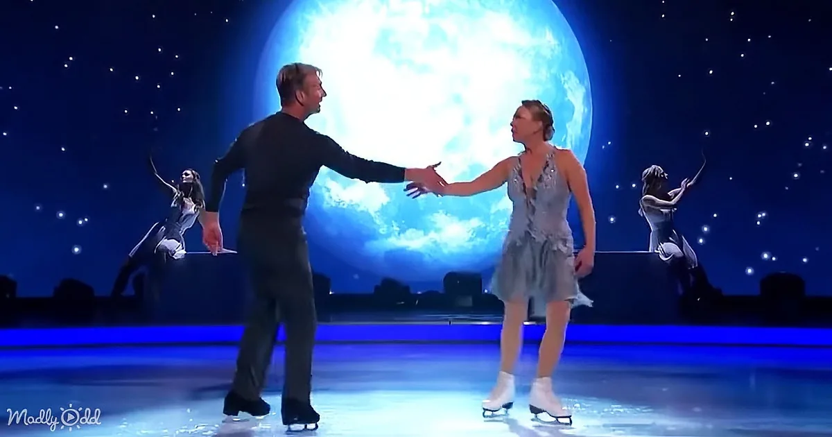 A couple in a skating pose, holding hands, with a large moon and stars in the background.