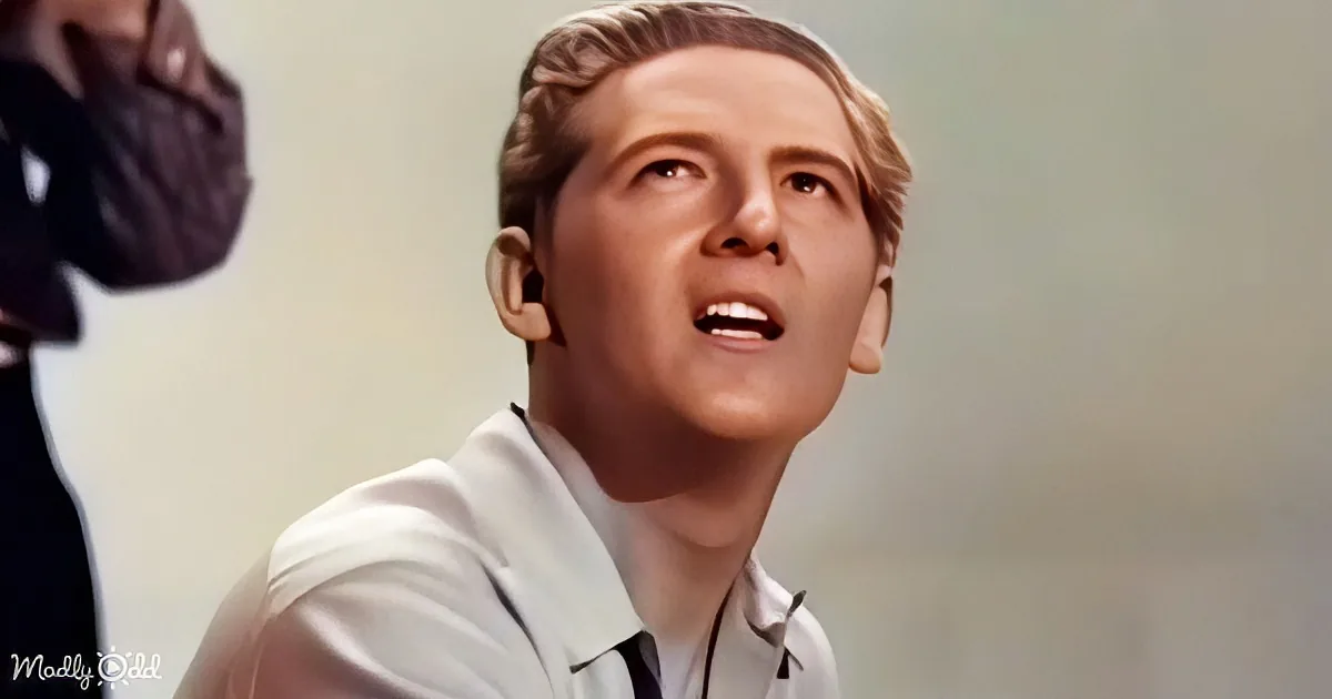 A man in a light-colored shirt is singing with his eyes closed, mouth open, and head tilted back.