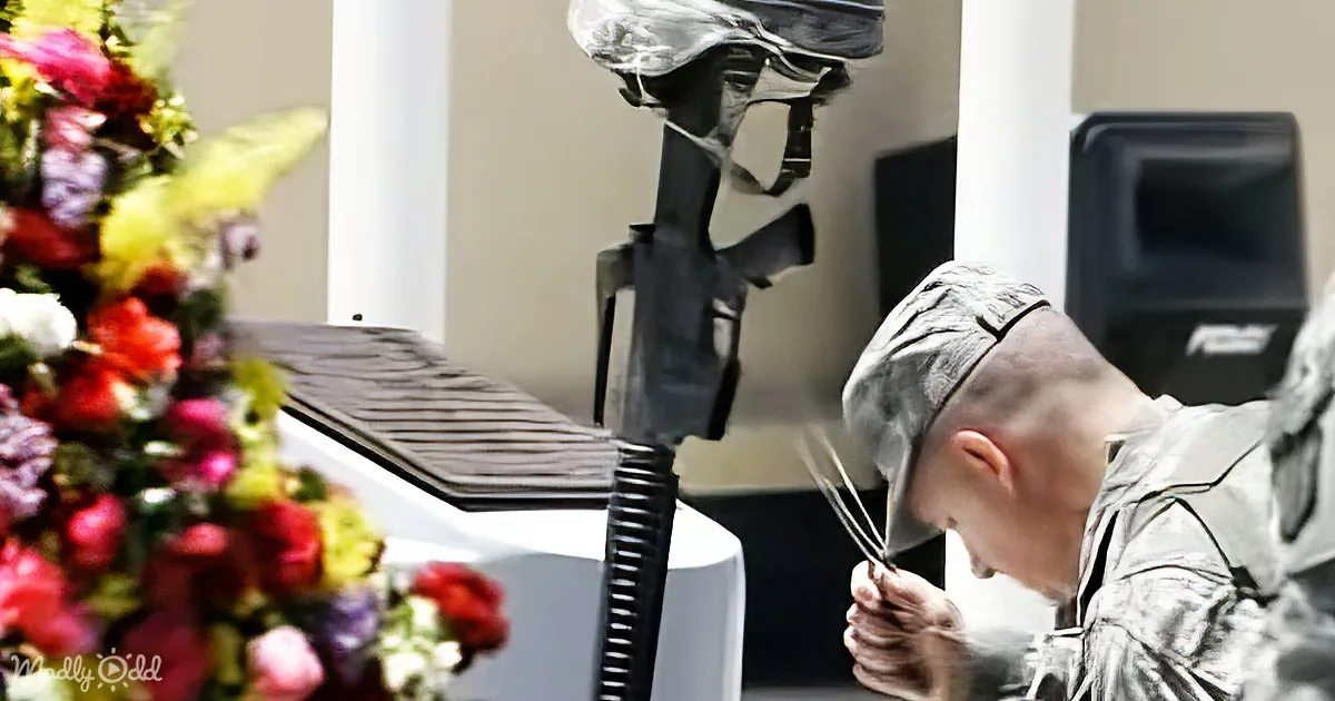 A soldier in uniform is cutting a flower arrangement with scissors.