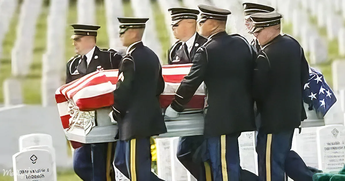 Uniformed military personnel carry a casket draped with an American flag at a solemn funeral ceremony.