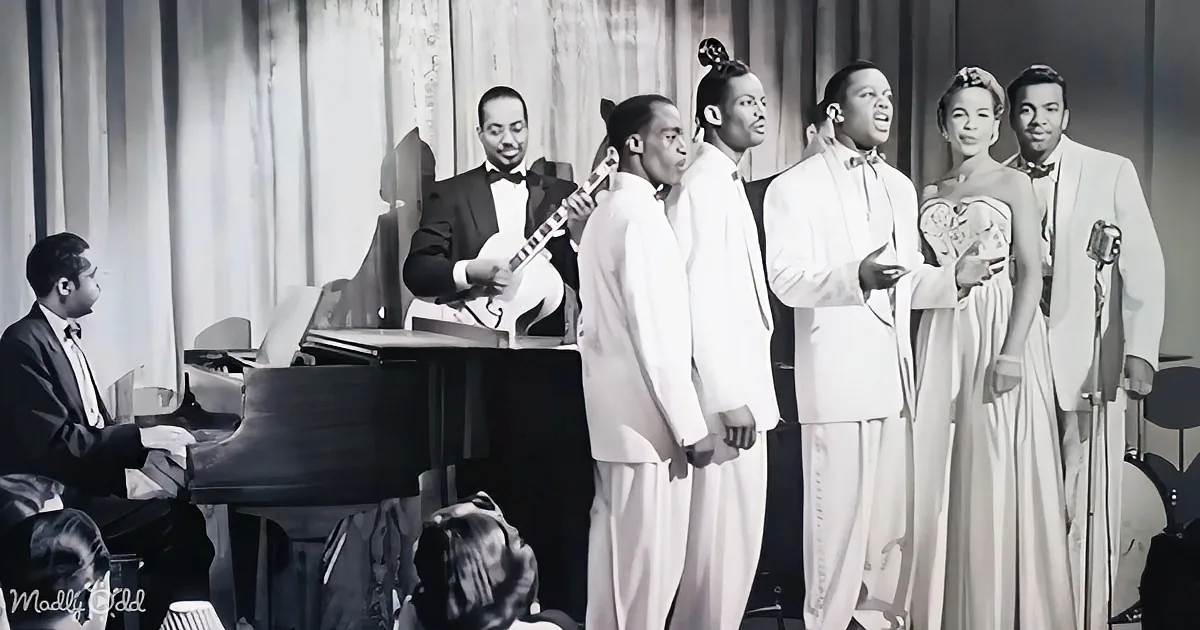 A jazz band in formal attire performs on stage, with a pianist, guitarist, and vocalists.