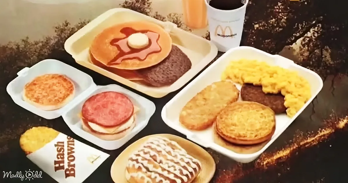 A McDonald's breakfast tray with pancakes, hash browns, sausage, eggs, and a donut.