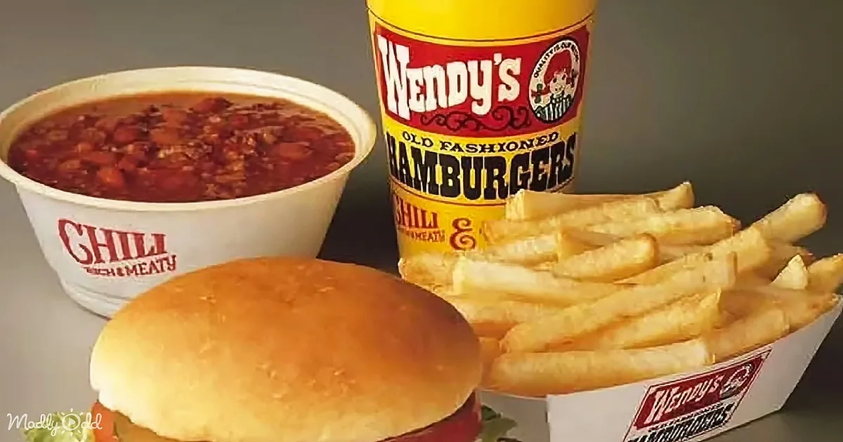 A Wendy's meal featuring chili, hamburger, and fries in branded containers.