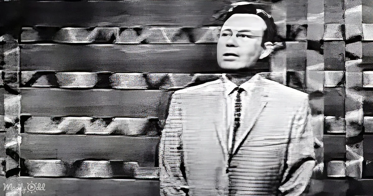 A man in a suit and tie appears to be made of wood, standing against a wooden wall.
