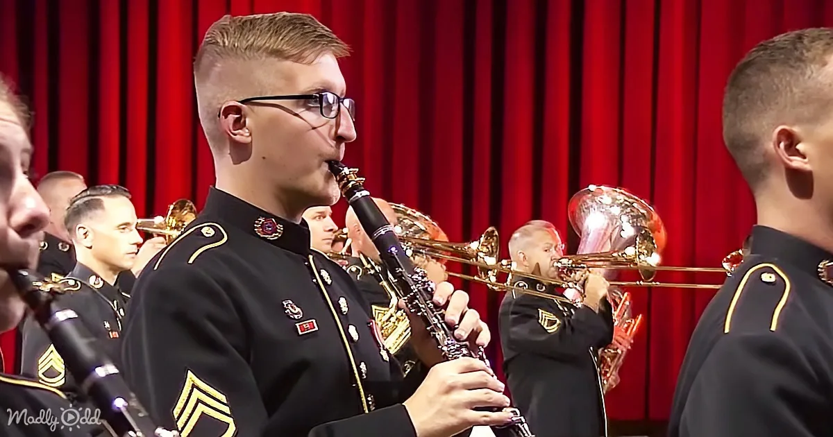 A man in a military uniform plays a clarinet in a band with other musicians.