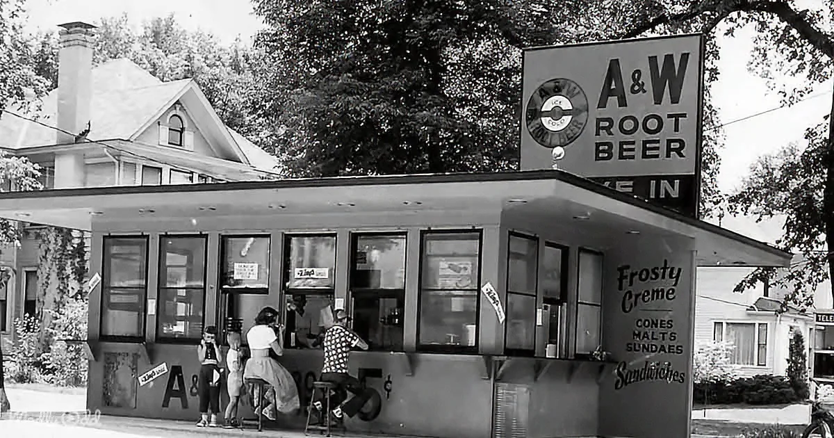 A&W Root Beer restaurant with people eating, vintage sign, and classic diner atmosphere.