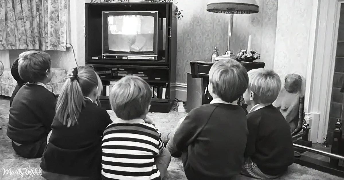 Children sit on the floor, intently watching an old television in a cozy, vintage living room.