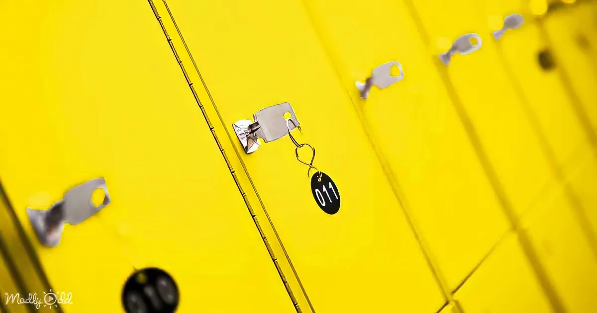A key with the number 011 hangs from a yellow locker, surrounded by other keys.