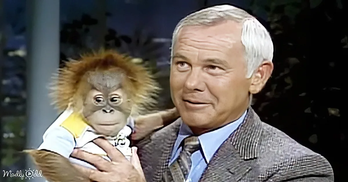 A man in a suit holds a baby orangutan, both appearing calm and content.