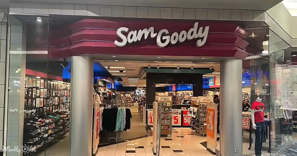 Sam Goody store with shoes, clothing, and clearance signs inside.