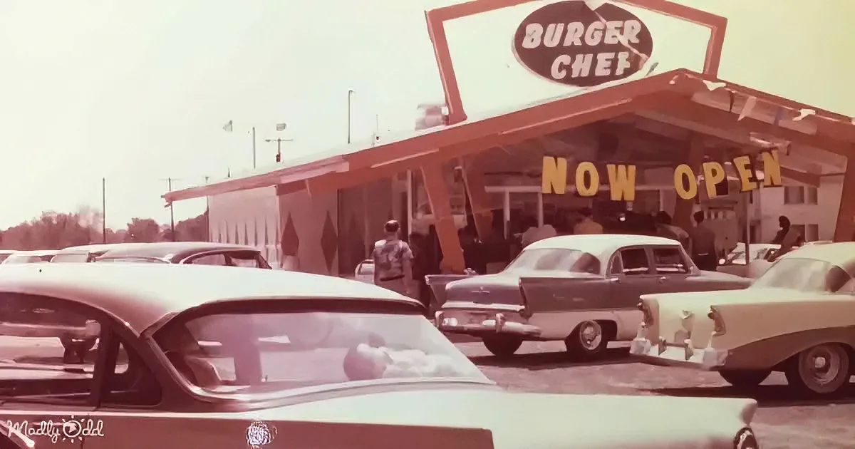 Burger Chef restaurant with "Now Open" sign, classic cars parked in front, vintage atmosphere.