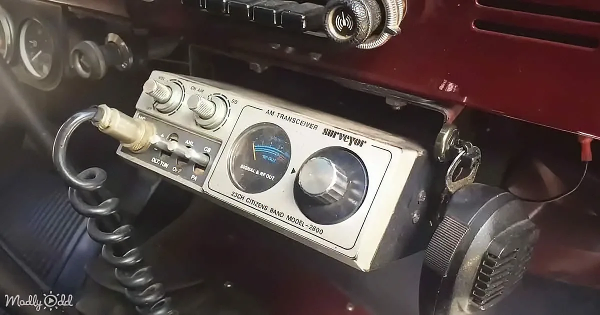 A vintage AM transceiver labeled "Surveyor" with 23 channels for Citizens Band communication is mounted on a vehicle...