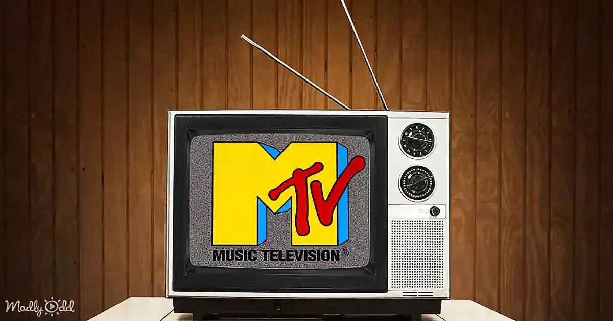 An old TV displays the MTV Music Television logo against a wooden-paneled background.