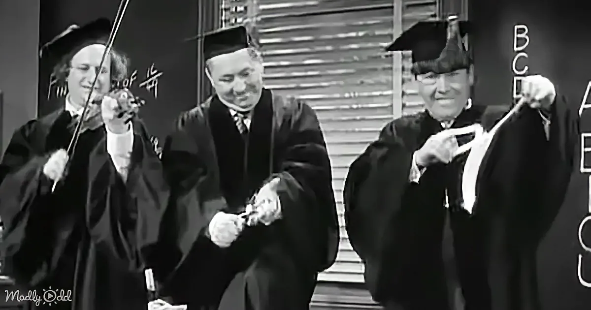 Three individuals in academic robes and caps are holding rolled-up documents, possibly celebrating or presenting.