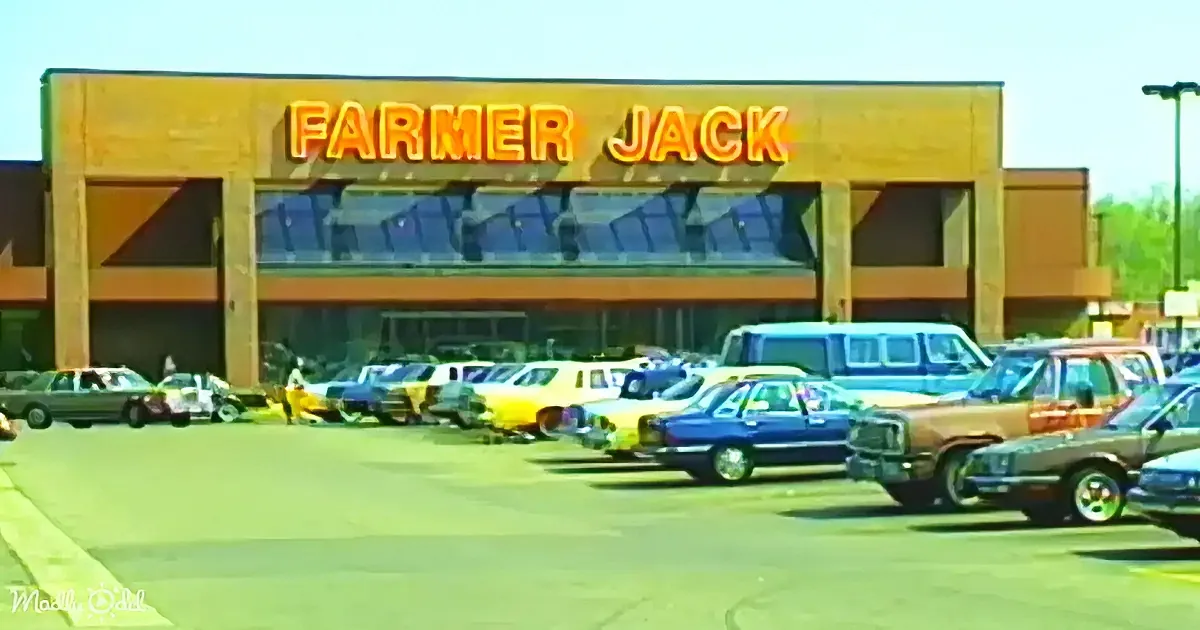 Farmer Jack store with vintage cars parked in front on a sunny day.