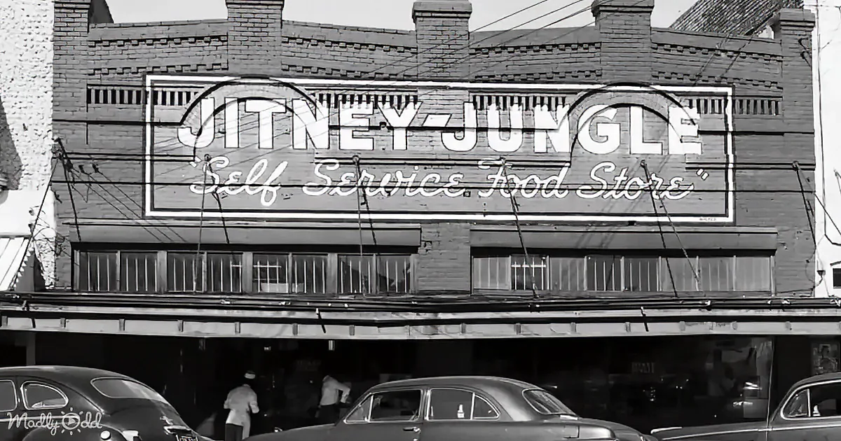 A vintage storefront with a sign reading "Jitney Jungle Self Service Food Store" above a brick building.