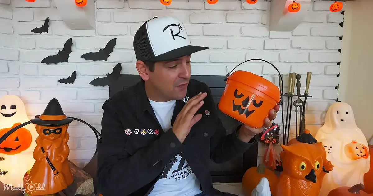 Halloween-themed buckets and toys, including ghosts and pumpkins, are displayed on a table.