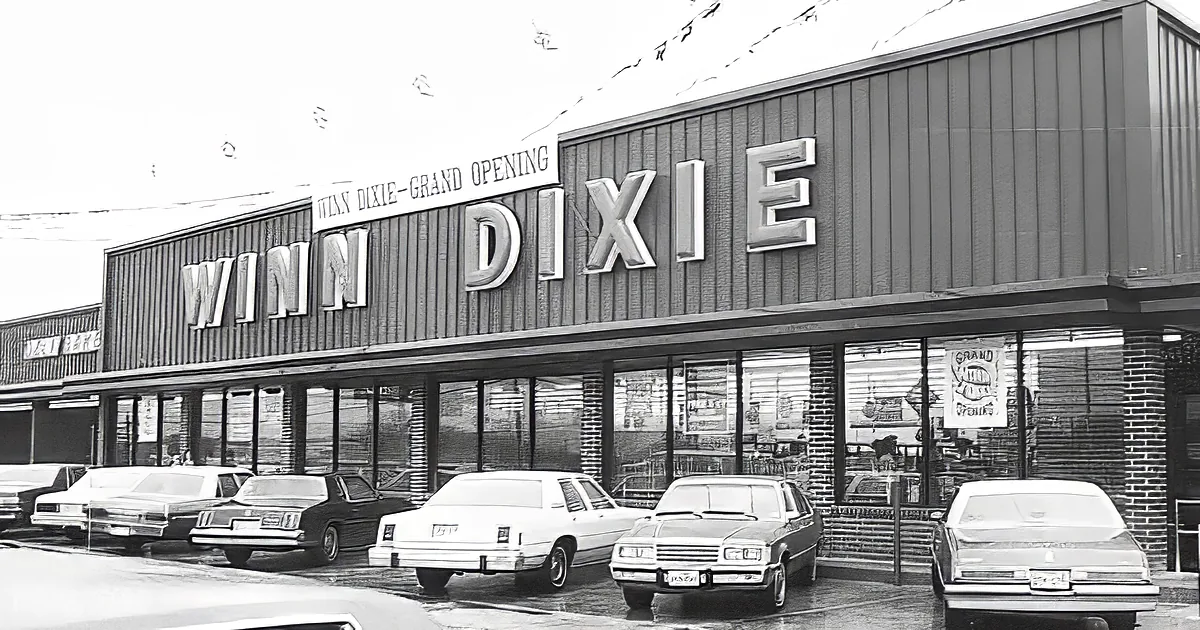 Winn Dixie store with cars parked in front, sign reads "Winn Dixie Grand Opening."