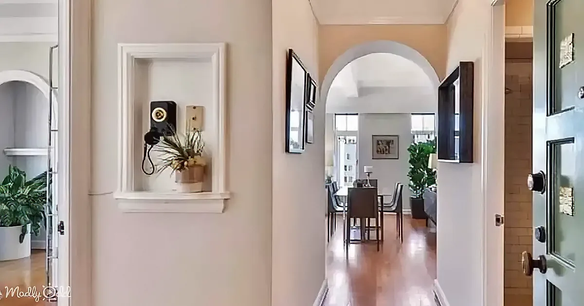 A decorative metal scroll, a white door with bottle design, and a wall shelf with a vintage phone and bottle caps.