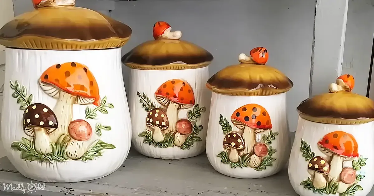 Four ceramic mushroom-themed canisters with detailed mushroom designs and gold lids.