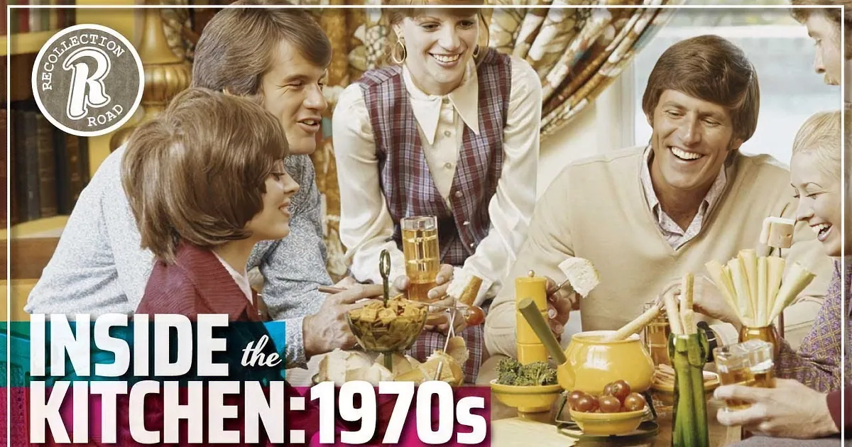 A group of six people is gathered around a table, enjoying a meal and drinks, with a warm and cheerful atmosphere.