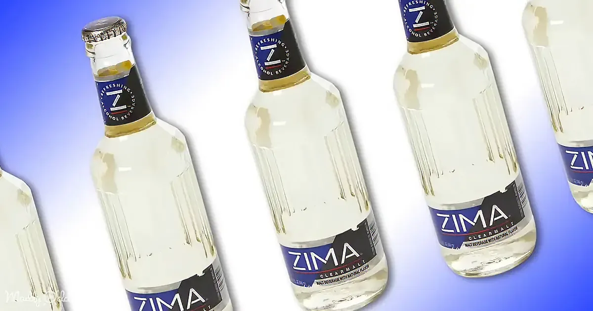 Several Zima malt beverage bottles with labels and caps, some with condensation, against a gradient blue background.