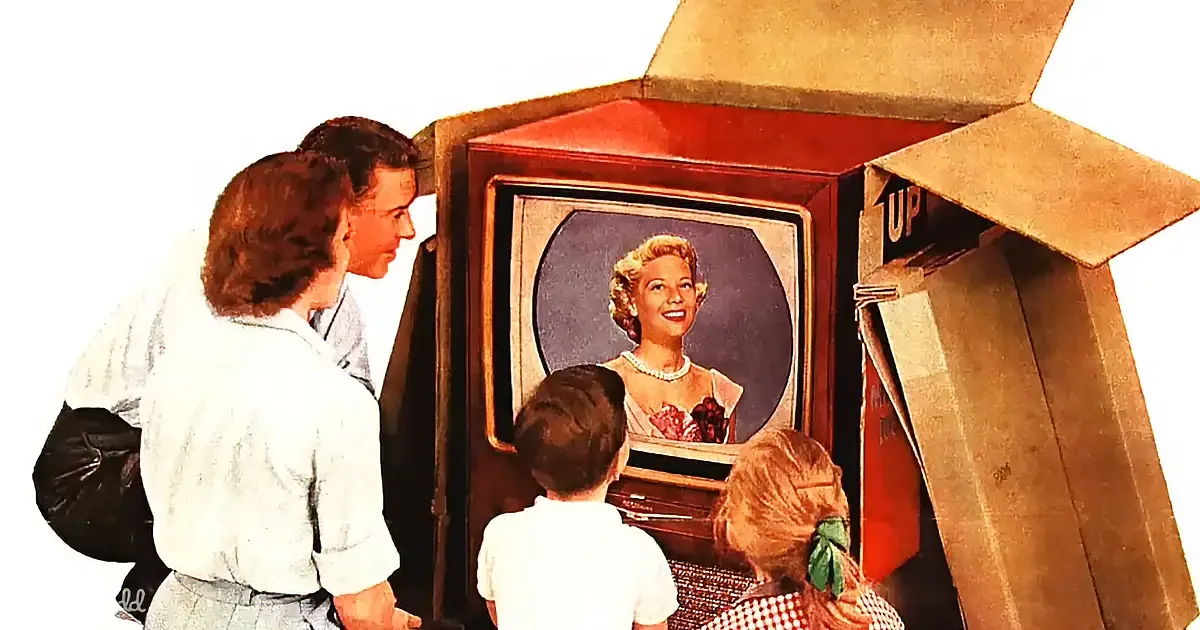 A family watches a vintage television with a woman on screen, surrounded by cardboard boxes.