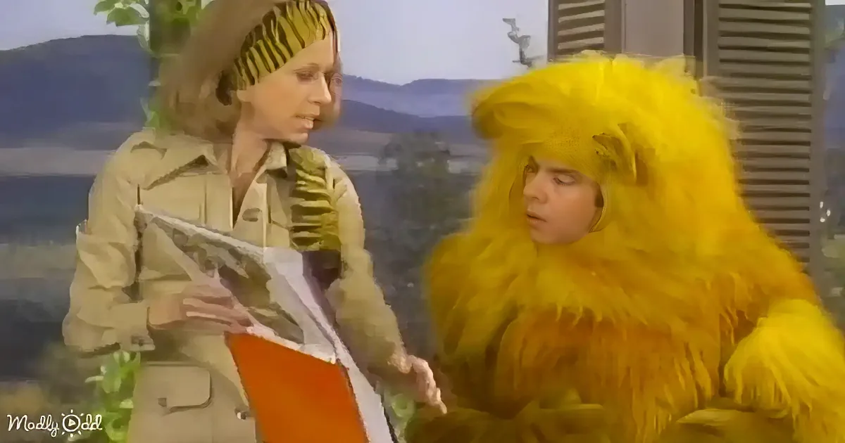 A person in a yellow furry costume holds a book, interacting with another person in a beige outfit.