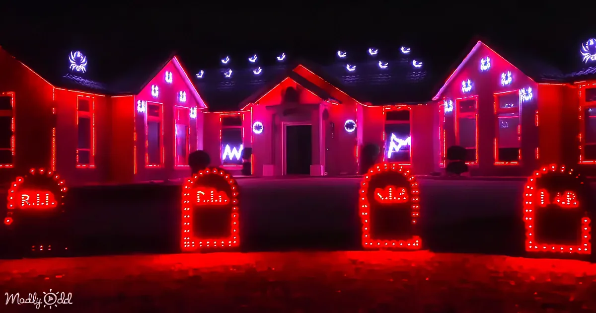 Red-lit graves with "R.I.P." and a house with glowing blue and red lights in the background.