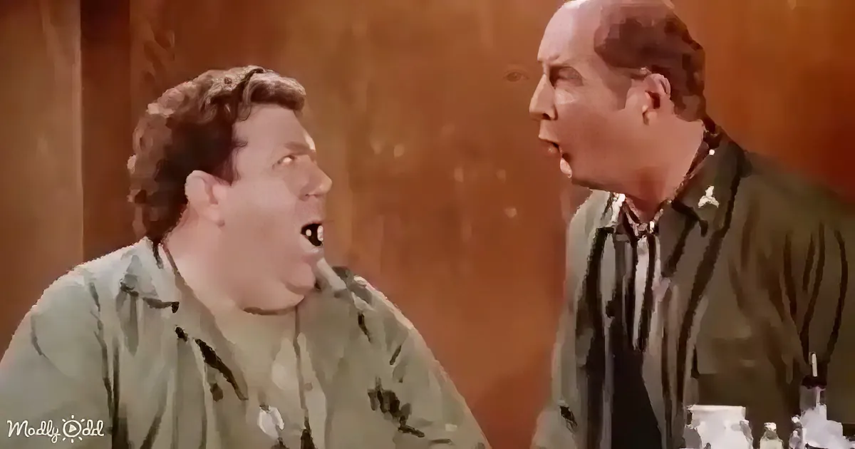 Two men in green shirts are engaged in a conversation, one appearing to speak emphatically.