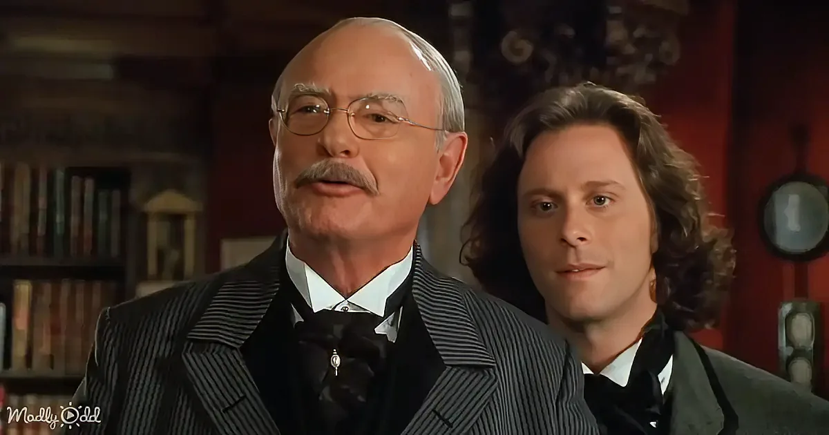 An older man in a pinstripe suit and bow tie stands beside a younger man with curly hair, both in formal attire.