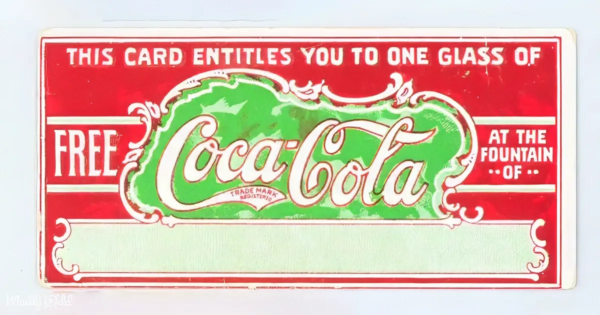 A vintage Coca-Cola card offers a free glass of soda at the fountain.