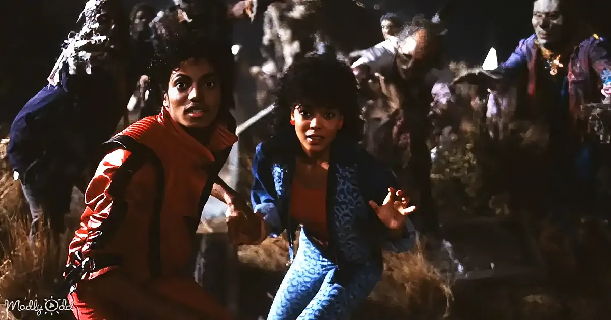 Michael Jackson and a young girl in a dark, grassy setting, surrounded by people in the background.