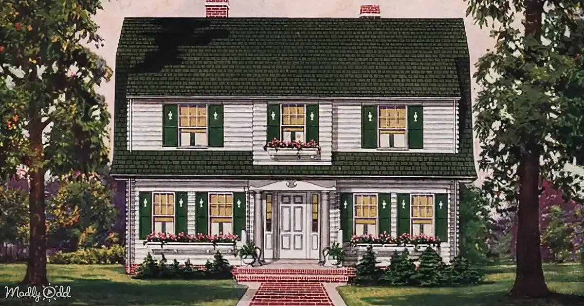 A charming two-story house with green shutters, white siding, and a brick walkway leading to the front door.