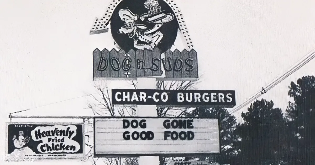 A sign advertises "Dog 'n Suds" with "Char-Co Burgers" and "Heavenly Fried Chicken," emphasizing "Dog Gone Good Food."
