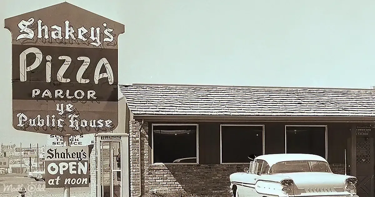 A vintage Shakey's Pizza Parlor and Public House sign with a classic car parked in front.