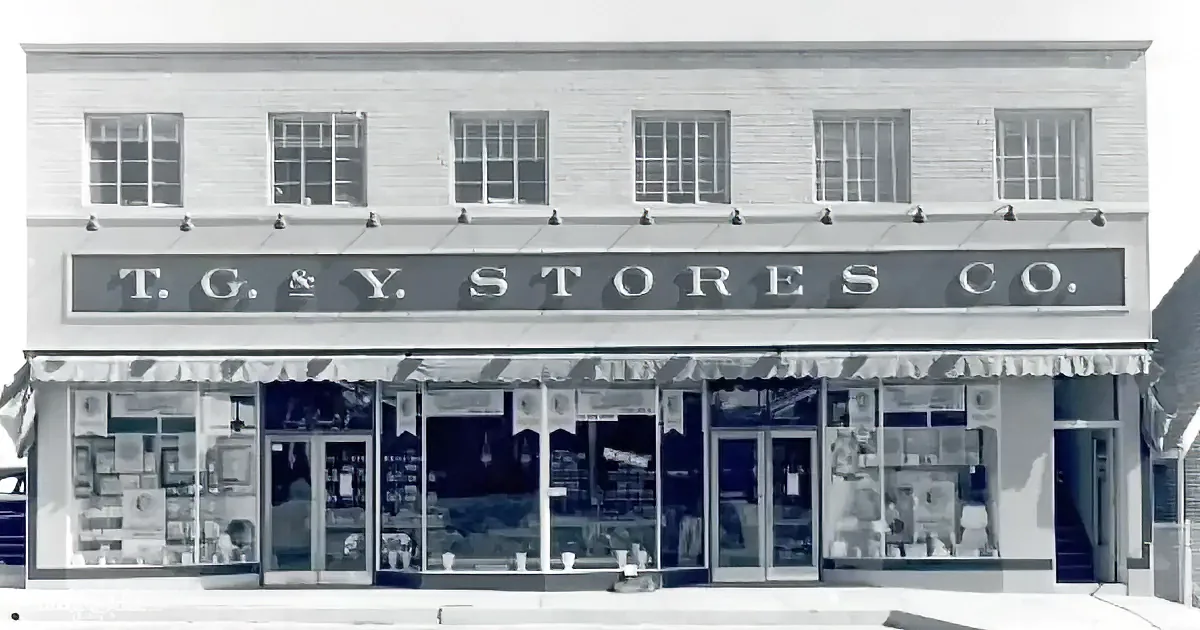 T.G. & Y. Stores Co. building with large windows and awning, showcasing vintage storefront.